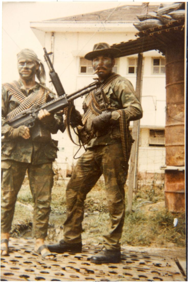 Two badass looking U.S. Navy Seals, one wearing sandals