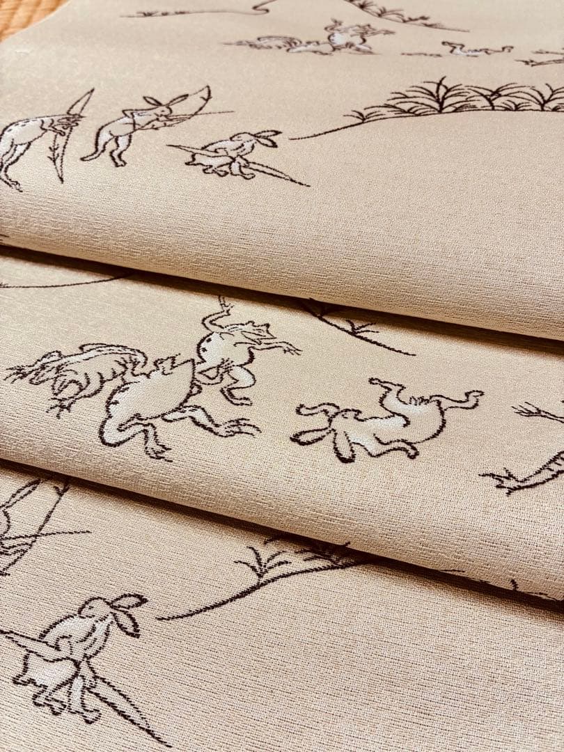 素敵な装い！西陣名古屋帯 綿芯仕立付 「鳥獣人物戯画」クリーム