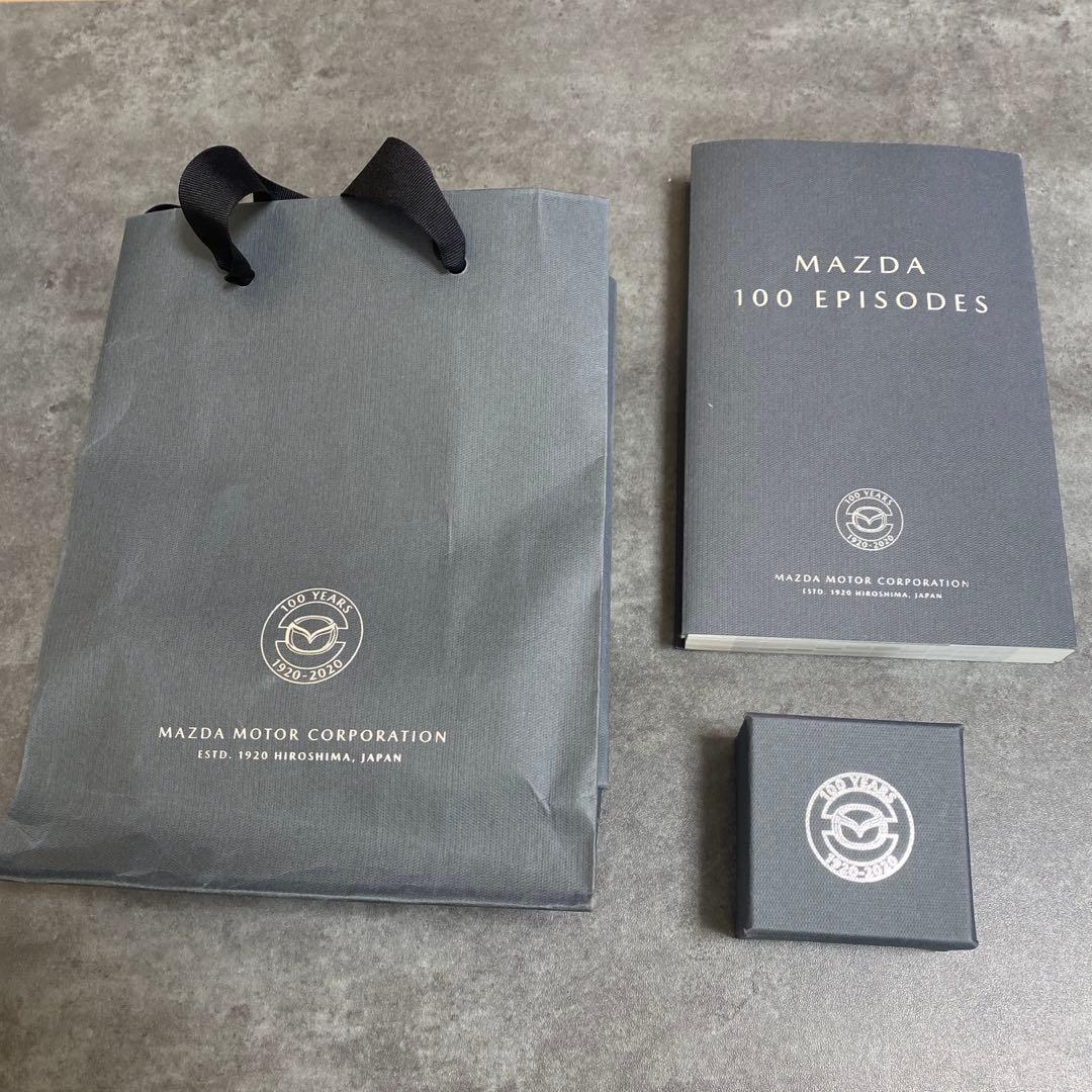 非売品】マツダ100周年 マツダ百年史 エピソード編と記念バッジ - メルカリ