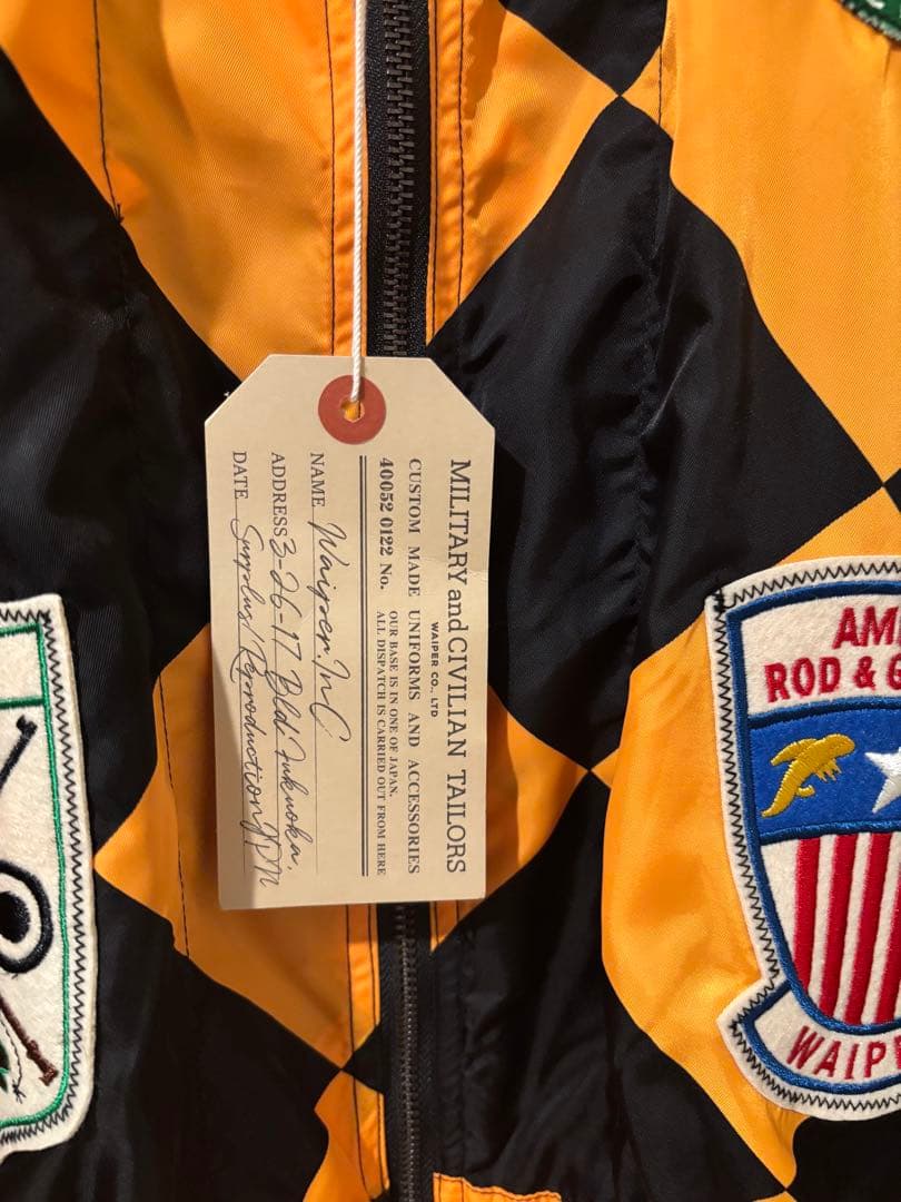 オレンジと黒のチェック柄ナイロンジャケット - メルカリ